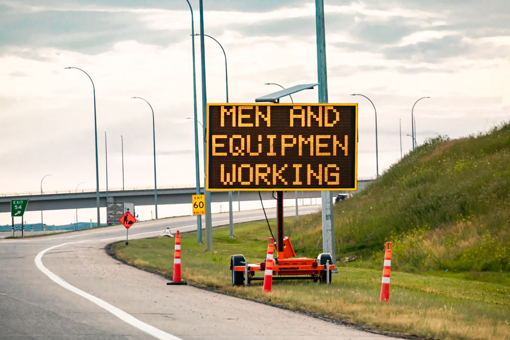 Temporay condition variable message sign with orange barrels