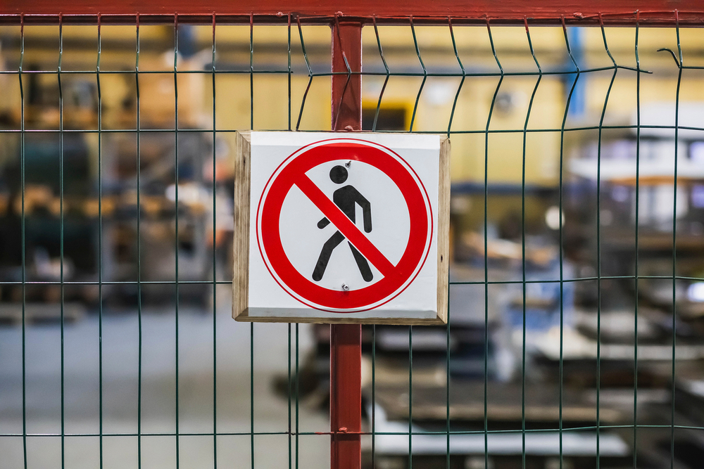 No entry (prohibition) sign on the fence at a factory